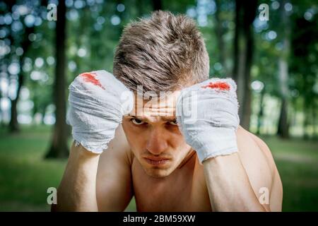aggressive boxer diligently trains hands in blood Stock Photo