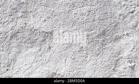 panoramic construction background - white colored uneven plastered outdoor wall illuminated by sun Stock Photo