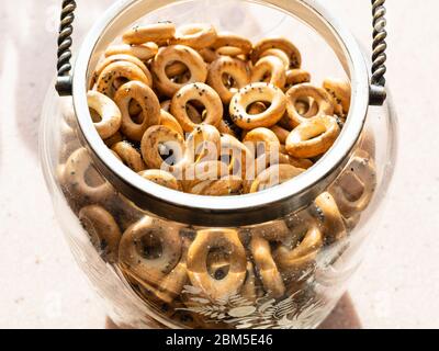 many Sushki with poppy seeds (traditional Eastern European crunchy bread rings) in vintage glass jar Stock Photo