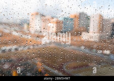 Waterdrops on a glass surface windows with cityscape background Stock Photo