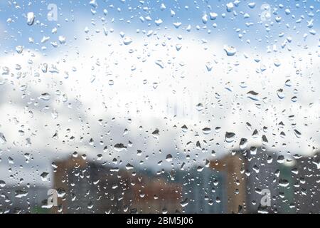Waterdrops on a glass surface windows with cityscape background Stock Photo