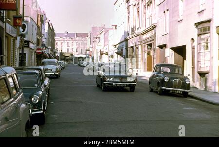 Bristol in the 60s and 70s:  View of Princess Victoria Street in Clifton in June 1970 looking towards Regent Street.  A Rover 2000 saloon passes a parked Austin A35 in what is now known as Clifton Village, where parking pressures have brought controlled parking zones. The area was popular with Bristol University students in those pre-central heating days with many buildings split into flats and rented out on yearly lets with few of the occupants having cars. Stock Photo