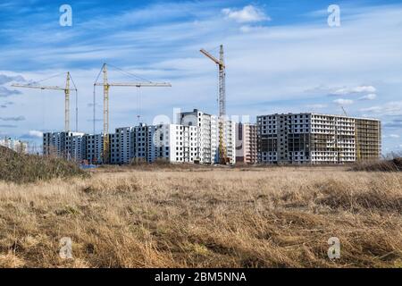 Construction of a multi-unit residential complex in an abandoned agricultural field in spring Stock Photo