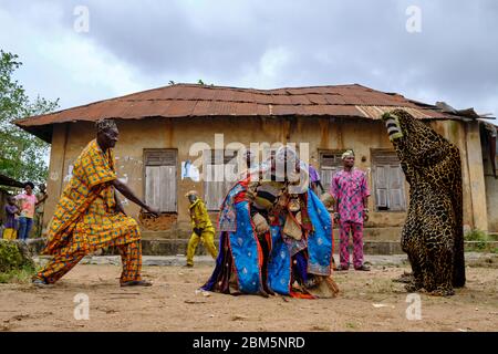 Man dressed with an Egungun mask performing during a ritual dance. The Egungun is a Yoruba character that represents the ancestors in the religious ce Stock Photo