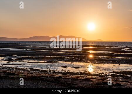 Arran sunset from beach at Greenan Castle, Heads of Ayr. Stock Photo