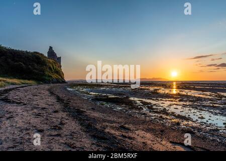 Arran sunset from beach at Greenan Castle, Heads of Ayr. Stock Photo