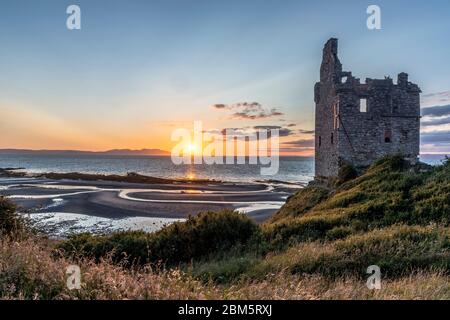 Arran sunset from beach at Greenan Castle, Heads of Ayr. Stock Photo