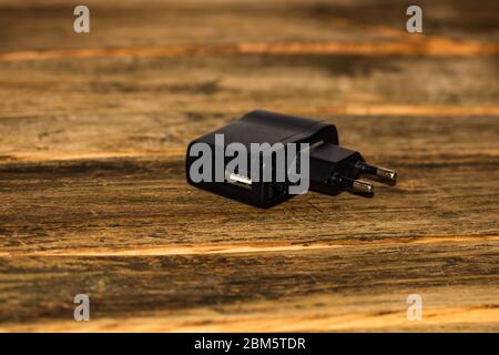 Black socket travel charger for USB port output. USB electronics device charger isolated, Stock Photo