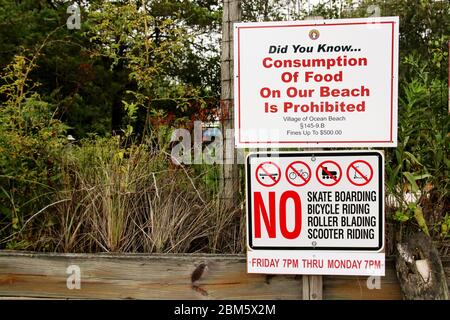 A sign in Ocean Beach Fire Island, NY that sais, no eating, skating, biking, roller blading and scooter riding, Stock Photo