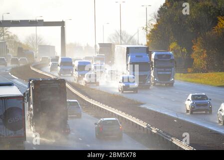 traffic travelling through heavy rain causing spray on A1/M motorway leeds yorkshire uk Stock Photo