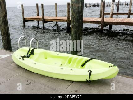 A light green kayak placed on a wooden dock over the great south bay in Fire Island New York. Stock Photo