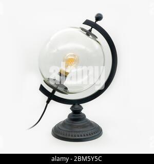 A glass globe lamp with a metal base, cut out on white background Stock Photo