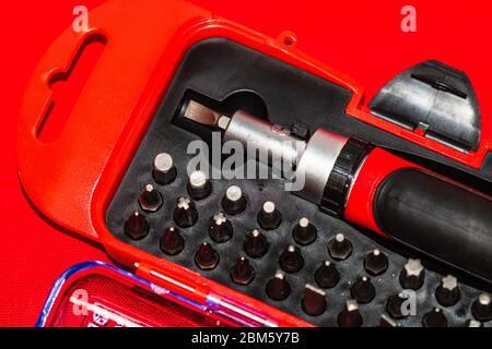 Close up of interchangeable screwdriver set with different types of metal steel heads and bits. Stock Photo