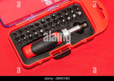 Close up of interchangeable screwdriver set with different types of metal steel heads and bits. Stock Photo