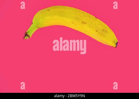 Yellow banana shape on pink background. Banana Minimal. Pastel colors style. Popart. Digitalart. Surreal. Pop. Creative. Minimalist art. Banana Stock Photo