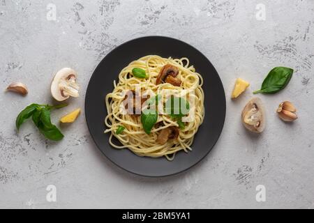 Mushroom pasta in a creamy sauce with cheese on a light background. View from above Stock Photo