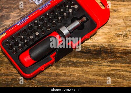 Close up of interchangeable screwdriver set with different types of metal steel heads and bits. Stock Photo