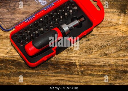 Close up of interchangeable screwdriver set with different types of metal steel heads and bits. Stock Photo