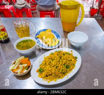Vietnamese breakfast, with omelet, rice, vegetables and tea, Vinh, Vietnam Stock Photo