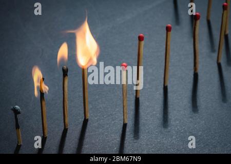 Match sticks burn, one piece prevents the fire from spreading - the concept of how to stop the covid-19 coronavirus from spreading: stay at home Stock Photo