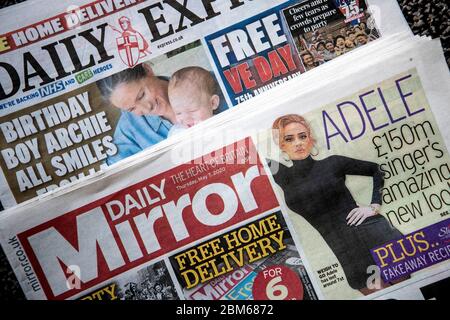 Copies of the Daily Express and Daily Mirror newspapers. The publisher behind the Mirror and Express newspapers has revealed a slump in advertising revenues as companies rein in spending due to the coronavirus outbreak. Stock Photo