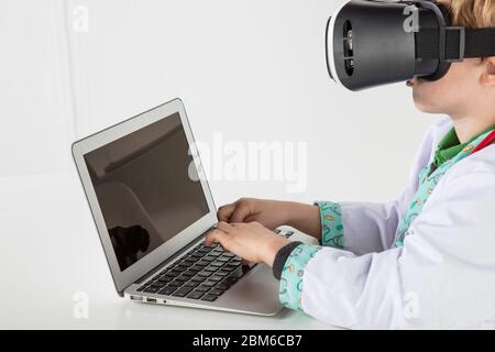 young doctor in virtual reality goggles is working on a 3D model of the virus Stock Photo
