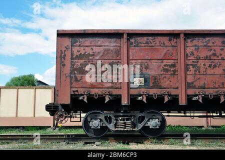 railway freight car on rails for the transport of industrial goods. Stock Photo