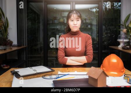 Female architect working with new startup project and thinking about her project at home office. Stock Photo