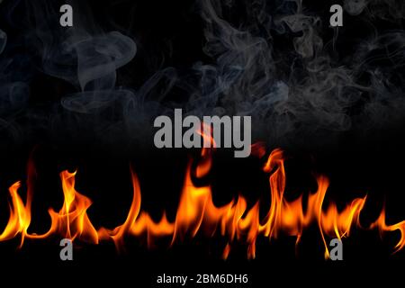 Fire flames with smoke on black background, Burning red hot sparks rise, Fiery orange glowing flying particles Stock Photo