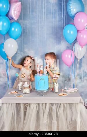 Children's funny birthday party in decorated room. Happy kids celebrate International Children's Day. Funny kids Stock Photo