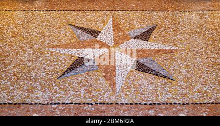 Portico flooring background. Texture of classic italian type of floor in Venetian style with a wind rose in the middle. Stock Photo