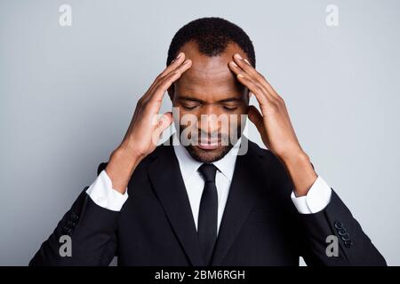 Close-up portrait of nice attractive tired overworked overwhelmed guy banker economist financier feeling bad touching forehead spasm chronic disease Stock Photo