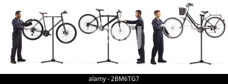 Men working in a bicycle repair workshop isolated on white background Stock Photo