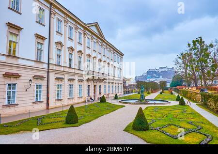 SALZBURG, AUSTRIA - MARCH 1, 2019: The scenic view on Mirabell Palace with its gardens and Hohensalzburg castle on the background, on March 1 in Salzb Stock Photo