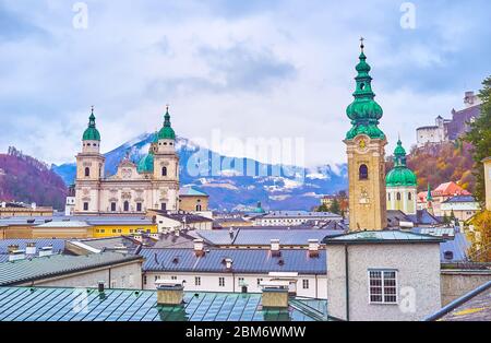 The rainy day in old Salzburg with a view on medieval Cathedral, slender belfry of St Peter's Abbey and city roofs from the Monchsberg hill, Austria Stock Photo