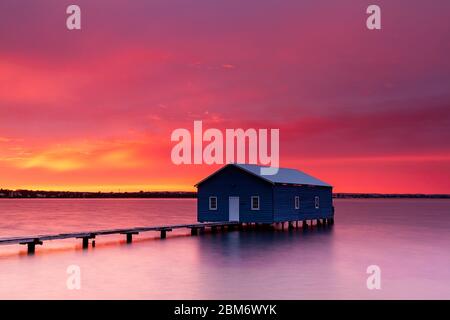 Sunrise at the blue boat house on the river Stock Photo