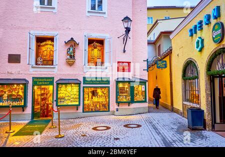 SALZBURG, AUSTRIA - MARCH 1, 2019: The leisure walk in medieval Altstadt district and explore historical city stores, taverns and breweries, on March Stock Photo