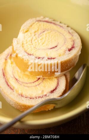 Slices of Arctic Roll dessert in a bowl Stock Photo