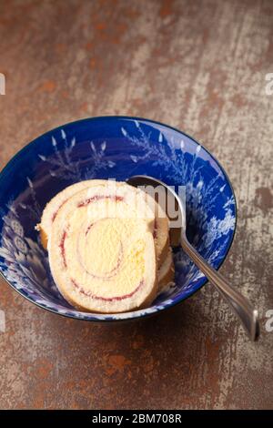 Slices of Arctic Roll dessert in a bowl Stock Photo