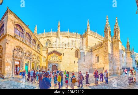 GRANADA, SPAIN - SEPTEMBER 27, 2019: Panorama of the queue in Calle Oficios (La Lonja square) in front of ornate Gothic style Capilla Real (Royal Chap