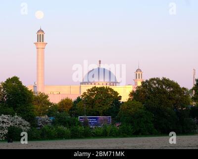 This year's final Supermoon rises on 6th May 2020 from behind the Baitul Futuh mosque in SW London. May's moon is known as the Flower moon. Stock Photo