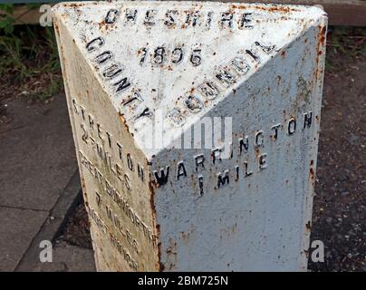 Rusted mile post to Warrington, Stretton etc, in London Road, Stockton Heath, Warrington, Cheshire, England, UK, WA4 6SG - 1896 Stock Photo