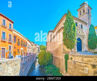 GRANADA, SPAIN - SEPTEMBER 25, 2019: Darro river is boardered with high banks and lined with such highlights of Albaicin as Santa Ana Church and Carre Stock Photo