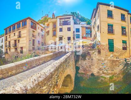 GRANADA, SPAIN - SEPTEMBER 25, 2019: Panorama of Cabrera bridge and foot of Sabika hill with old living buildings, cafes, bars, hotels and other touri Stock Photo