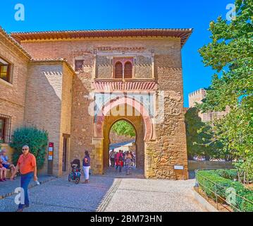 GRANADA, SPAIN - SEPTEMBER 25, 2019: People walk through the medieval Wine Gate (Puerta del Vino) - the oldest construction in Alhambra, on September Stock Photo