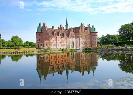 Egeskov Castle is located near Kvaerndrup, in the south of the island of Funen, Denmark. The castle is Europe's best preserved Renaissance water castl Stock Photo