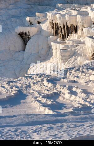 Travertines, white limestone mineral mountain with natural steps in Pamukkale, Turkey Stock Photo
