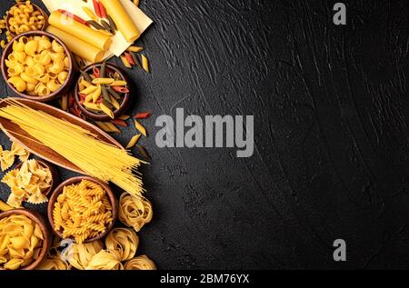 Different pasta types on black background with copy space for text Stock Photo