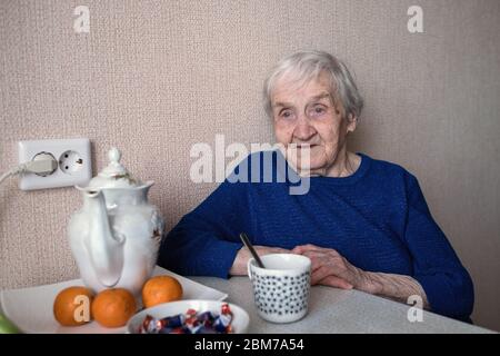 An old woman in her house portrait. Stock Photo