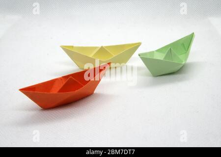 Colorful paper boats. Paper boats in a various colors on a white background. Stock Photo